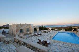 a villa with a swimming pool and a resort at Golden Sea Villas in Chrissi Akti
