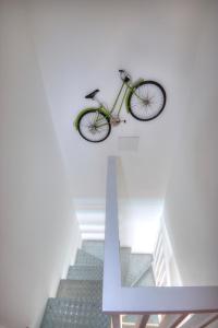 a bike hanging on the wall next to a staircase at Casa Cocodrilo in Playa del Ingles