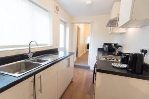 a kitchen with a sink and a counter top at Campbell House in Gainsborough