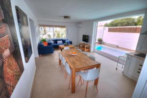 a living room with a table and chairs and a pool at Casa Cocodrilo in Playa del Ingles