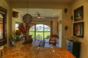 a kitchen and living room with a table and a dining room at Condominios Ballena in Cabo San Lucas