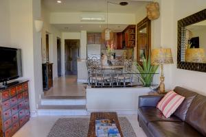 a living room with a couch and a dining room at Condominios Ballena in Cabo San Lucas