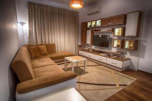 a living room with a couch and a television at Sunshine Sofia in Sofia
