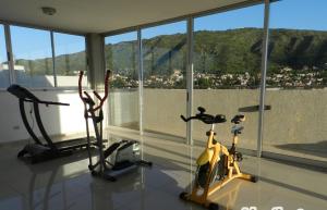 two exercise bikes in a room with a view of a city at Departamento Edificio Manhattan 7mo piso in Villa Carlos Paz