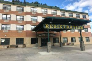 a building with a sign that reads registration at Travelodge by Wyndham Deadwood in Deadwood