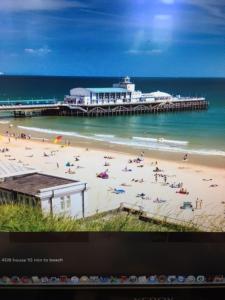 a view of a beach with people on the sand at Discoveries Guest House & luxury spa in Bournemouth