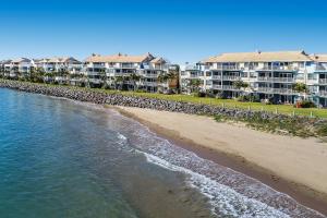 an aerial view of the beach in front of condos at BreakFree Great Sandy Straits in Hervey Bay