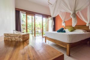 Postel nebo postele na pokoji v ubytování Arjuna Homestay