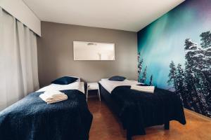 Säng eller sängar i ett rum på Hotel Kittilä