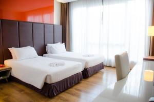 Ένα ή περισσότερα κρεβάτια σε δωμάτιο στο Prajaktra Design Hotel