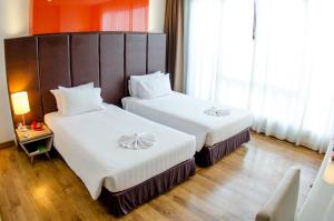 Ένα ή περισσότερα κρεβάτια σε δωμάτιο στο Prajaktra Design Hotel