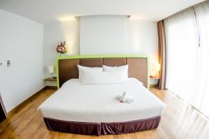 Ένα ή περισσότερα κρεβάτια σε δωμάτιο στο Prajaktra Design Hotel