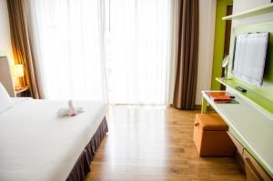 Ένα ή περισσότερα κρεβάτια σε δωμάτιο στο Prajaktra Design Hotel
