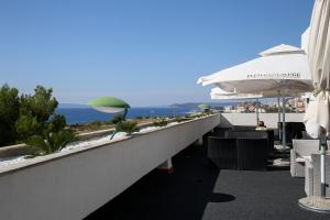 a beach area with a balcony overlooking the ocean at Hotel Zagreb in Split
