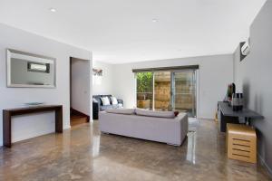 a living room with a couch and a table at Tides Port Fairy in Port Fairy