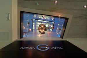 a display window of a store with a christmas tree at G Design Hotel in Ljubljana