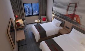 a small hotel room with two beds and a window at Thank Inn Chain Hotel Guangdong Zhuhai Doumen District Jing'an Bridge in Towmoon