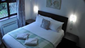 a bedroom with a large white bed with two pillows at Bay Lodge in Birchington