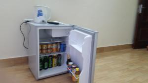 a small refrigerator with drinks in a room at Anh Duong Hotel in Thach Loi