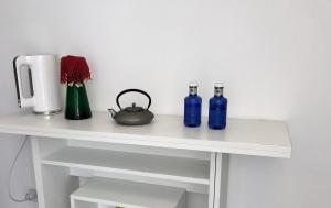 three blue bottles sitting on a white shelf at Lakescape Zurich in Herrliberg
