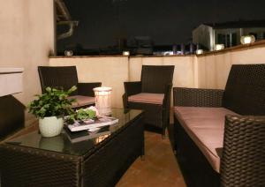 a room with chairs and tables and a table with a plant at Apartments Florence - Ricasoli Terrace in Florence