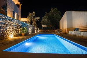 a swimming pool in a backyard at night at Villa Authentica Lopud, Dubrovnik in Lopud