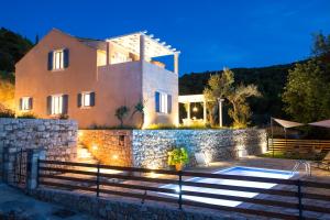 a house with a stone wall and a swimming pool at Villa Authentica Lopud, Dubrovnik in Lopud Island