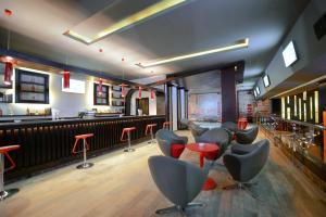 a bar with a row of chairs and a counter at Pickalbatros White Beach Resort - Hurghada in Hurghada