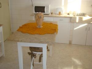 a kitchen with a table with a vase on it at Vivenda tilia in Pernes