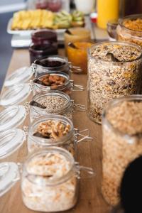 a table with many jars of food on it at Linnéplatsens Hotell & Vandrarhem in Gothenburg