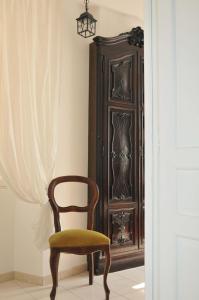 a chair and a cabinet in a room at Sea Apartment in Sanremo