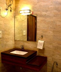 a bathroom with a sink and a mirror at Hotel Spiti in Mathura