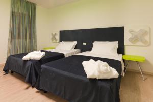 Voodi või voodid majutusasutuse VELANERA Hotel & Restaurant toas