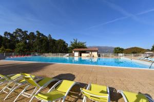 - un groupe de chaises et une piscine dans l'établissement Hôtel "U Nebbiu", à Oletta