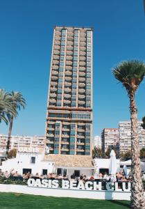 a large building with a large clock on top of it at Apartamentos Oasis Benidorm in Benidorm