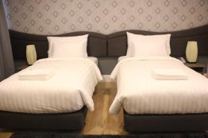 Postel nebo postele na pokoji v ubytování Avada Hotel