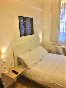 a bedroom with a bed and a tv on the wall at Appartamento Maggiore in Bologna