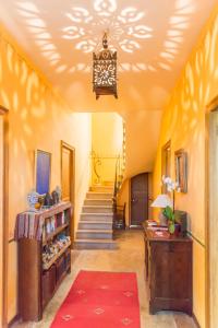 a hallway with stairs and a chandelier at Domaine Grand Guilhem in Cascastel-des-Corbières