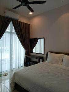 a bedroom with a bed and a ceiling fan at Imperial Cottage in Melaka +50 photos