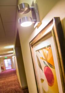 a hallway in a hotel with a painting on the wall at Curran Court Hotel in Larne