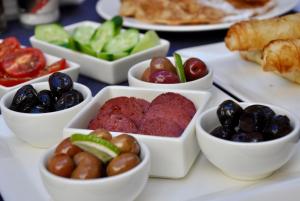 a table topped with bowls of different types of food at Ada Suites Nisantasi in Istanbul