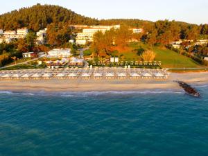 an aerial view of a beach with tables and chairs at Aegean Melathron Thalasso Spa Hotel in Kallithea Halkidikis