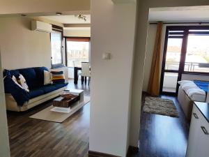 a living room with a couch and a table at Apartment "Central" in Yambol