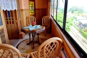 a dining room with a table and chairs and a window at Highcliffe Guest House in Haputale