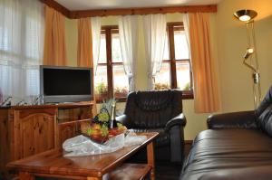 a living room filled with furniture and a tv at Hotel Izvora in Arbanasi