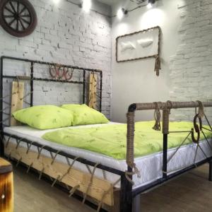 a bed in a room with a brick wall at Апартаменты Loft in Kansk