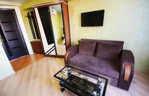 sala de estar con sofá marrón y mesa en Black Sea Star Batumi en Batumi