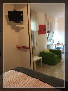 TavagnaccoにあるHotel Modernoのリビングルーム(緑のソファ、鏡付)