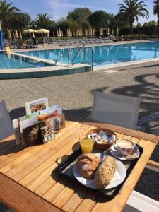 a tray of food on a table next to a pool at Hapimag Resort Scerne di Pineto in Scerne