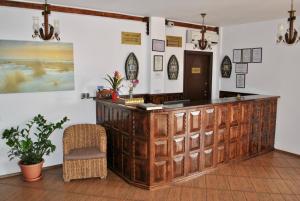 a wooden counter in a room with a chair at Delta Marina in Sfântu Gheorghe